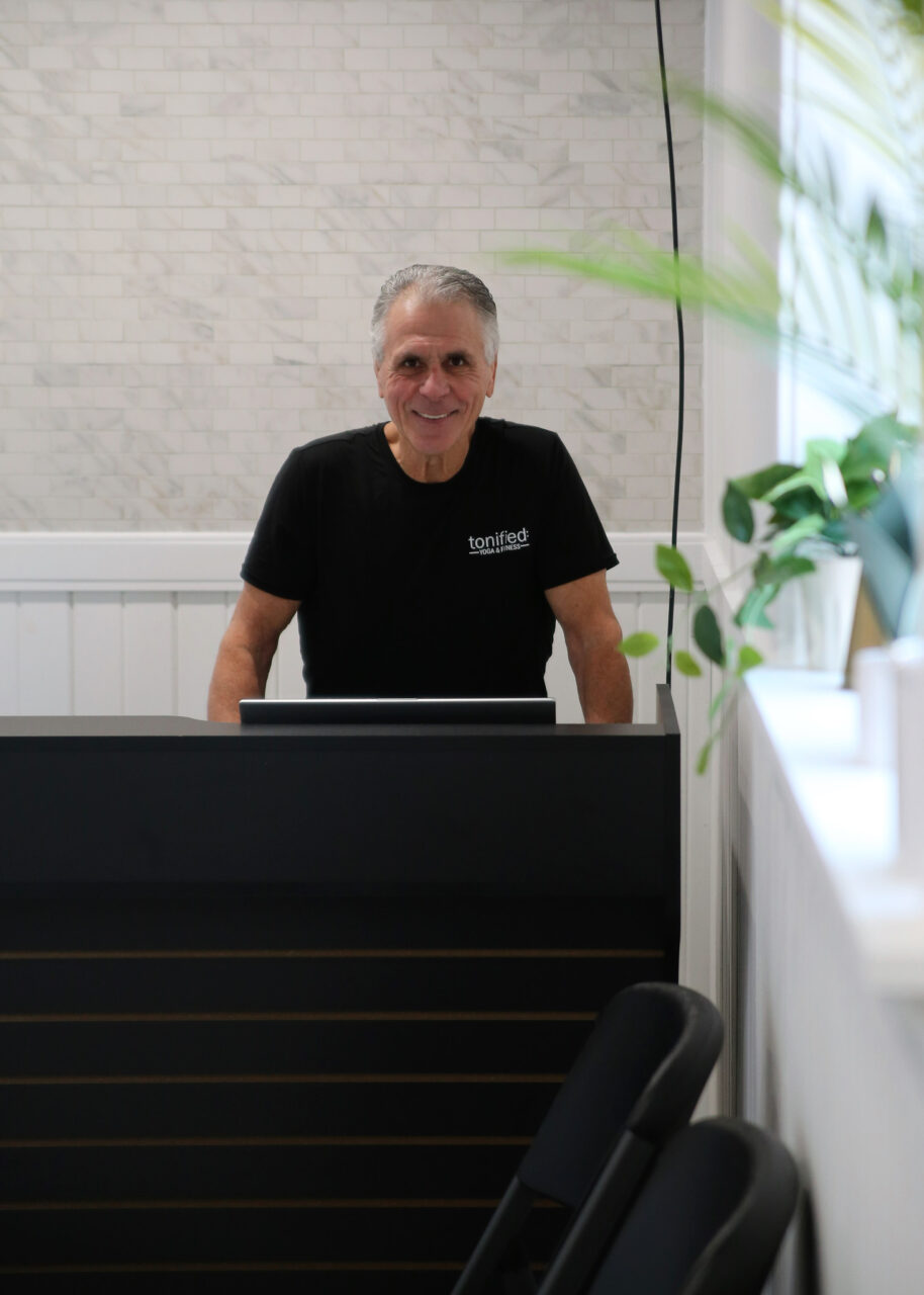 Tony smiling from behind the Tonified front desk
