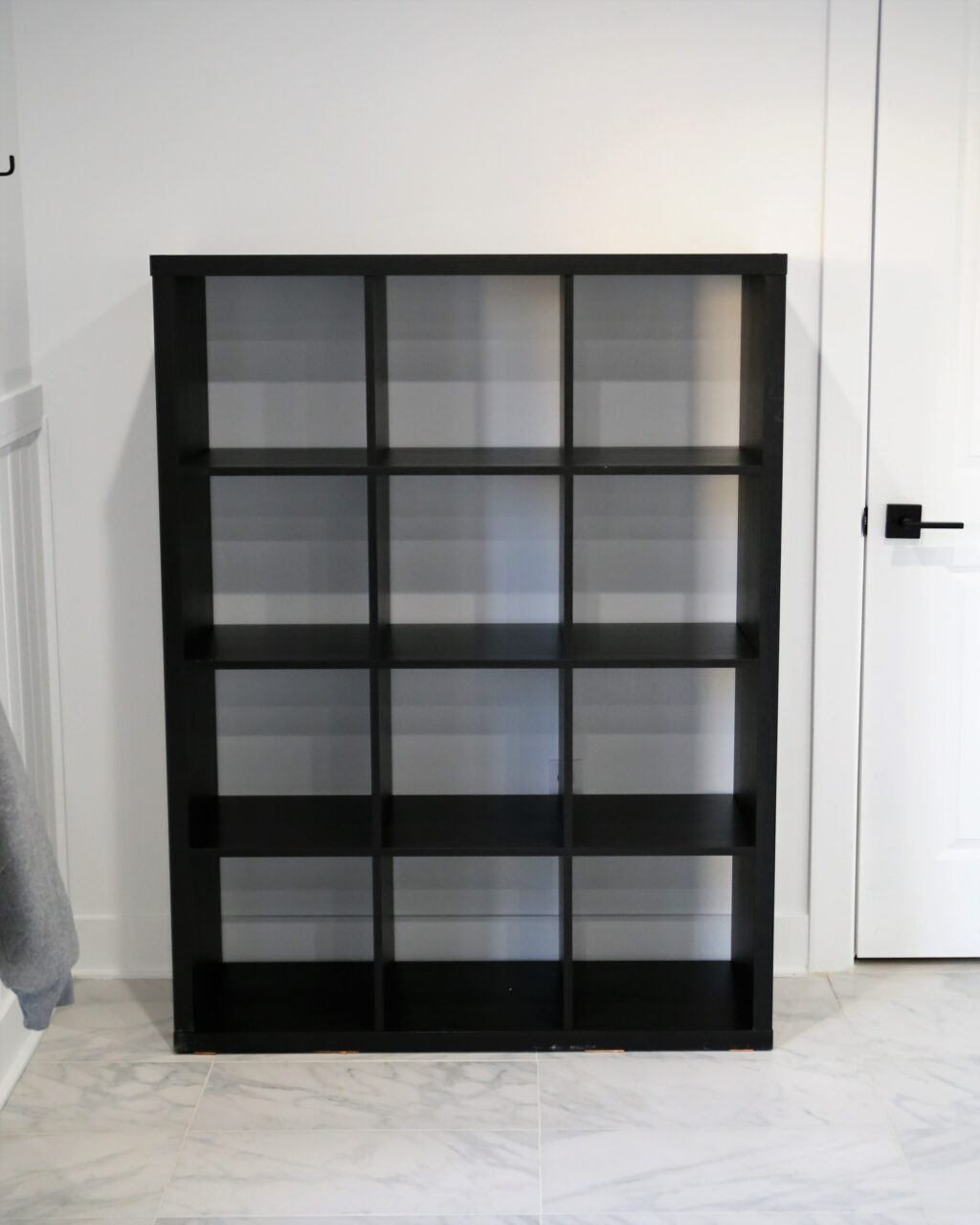 A black storage cabinet with 3 columns and 4 rows for students to store their personal items during class
